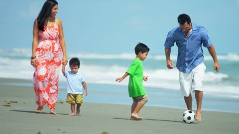Diverse attractive loving family spending holiday on beach playing soccer shot on RED EPIC
