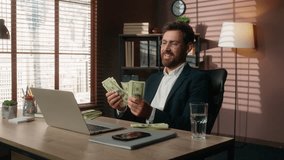 Happy excited cheerful smiling European business man counting money cash kissing banknotes love finance financial success at table rich male manager banker bank credit guy entrepreneur businessman - Powered by Shutterstock - Get 15% off with code: PIKWIZARD15