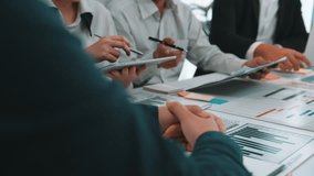 A diverse business team engages in a collaborative meeting, analyzing data and strategizing on project presentation, emphasizing teamwork and technological integration. SACTR - Powered by Shutterstock - Get 15% off with code: PIKWIZARD15