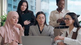 Professional multiethnic women females team African American Japanese Muslim hijab Arabian businesswomen talking online conference laptop video call business meeting discuss project paperwork office - Powered by Shutterstock - Get 15% off with code: PIKWIZARD15