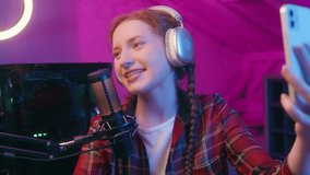 Smiling young woman girl teen gen z teenager gamer blogger streamer influencer record mobile phone video playing online computer game night streaming cyber sport social media gaming blog in neon room - Powered by Shutterstock - Get 15% off with code: PIKWIZARD15