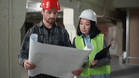 Multiethnic builders in uniform discussing blueprint inspection business engineers Caucasian man Korean woman hardhat discuss plan construction building project two workers partners technicians indoor - Powered by Shutterstock - Get 15% off with code: PIKWIZARD15
