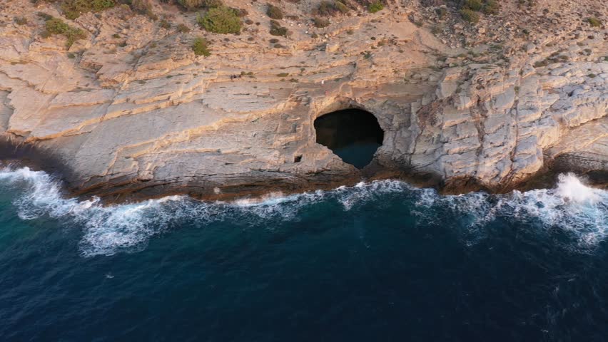 Flying above epic seaside natural rocky pool. Giola lagoon, Thassos island, Greece, aerial slow motion view