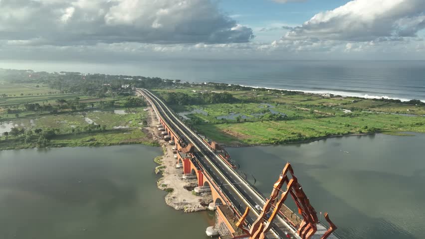 Drone view of Pandansimo Bridge crossing Progo River. DIY’s longest bridge joins Bantul and Kulonprogo with a cultural modern design.