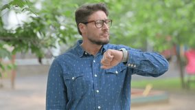 Middle Aged Man Checking Time on Smartwatch Outdoors - Powered by Shutterstock - Get 15% off with code: PIKWIZARD15