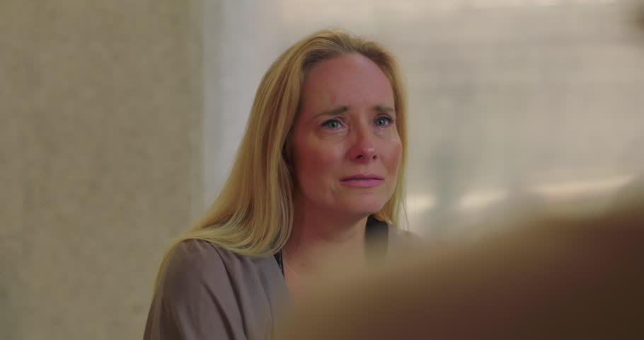 Crying woman overwhelmed with emotion during group therapy session, expressing pain and vulnerability in safe space of empathy, healing, and support