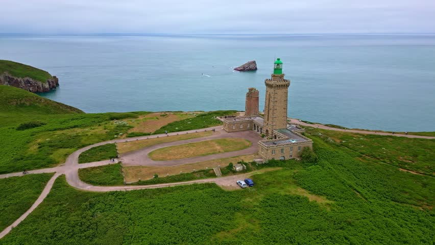 Panoramic drone movement around the Cap Fréhel peninsula lighthouse, Côtes-d'Armor, Brittany, France.