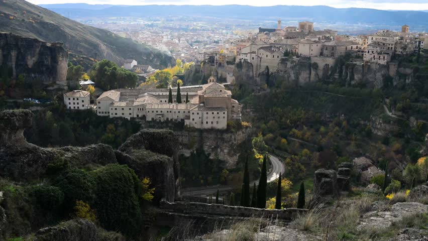 Across the deep gorge in Cuenca, Spain, the historic Convent of San Pablo faces the iconic Hanging Houses, presenting two distinct forms of UNESCO architecture.