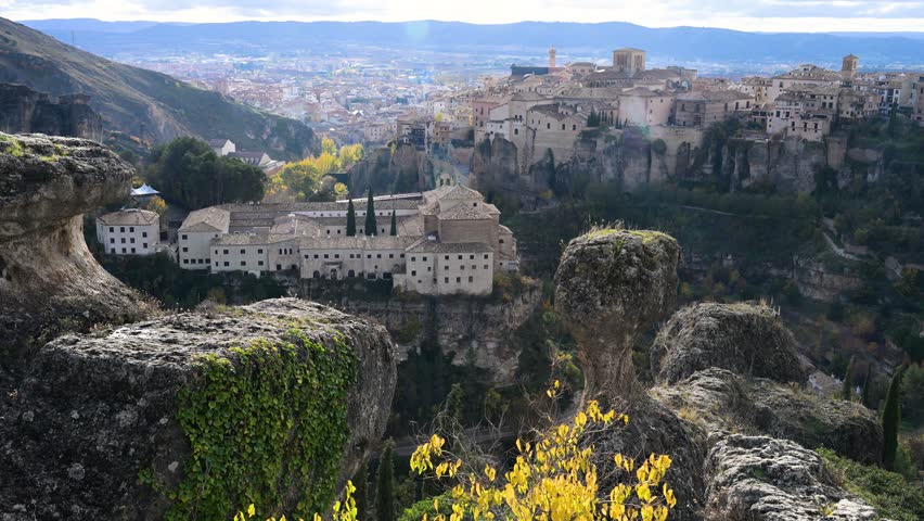 The historic Convent of San Pablo and the iconic Hanging Houses face each other across the dramatic Huecar gorge in the UNESCO city of Cuenca, Spain.