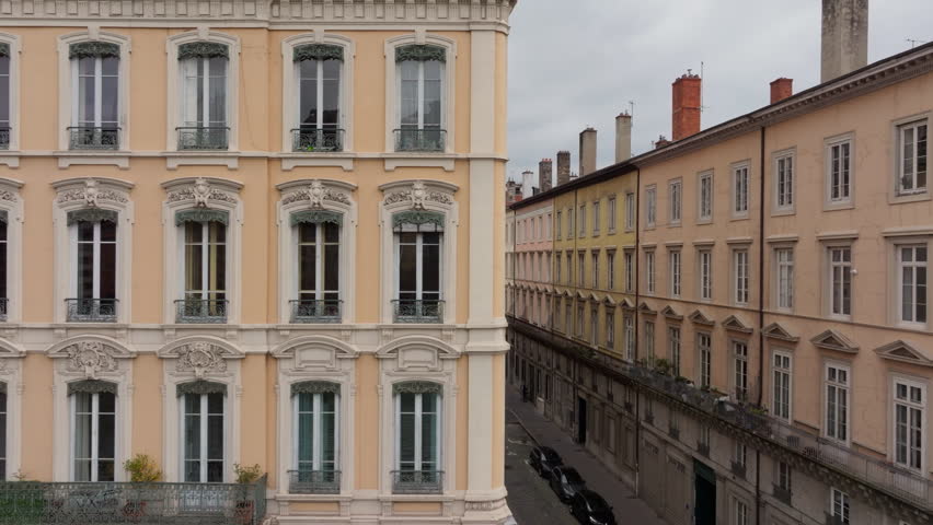 Lyon skyline displaying historic architecture, parked cars in the streets, downtown scenery, blending urban landscape with classic charm