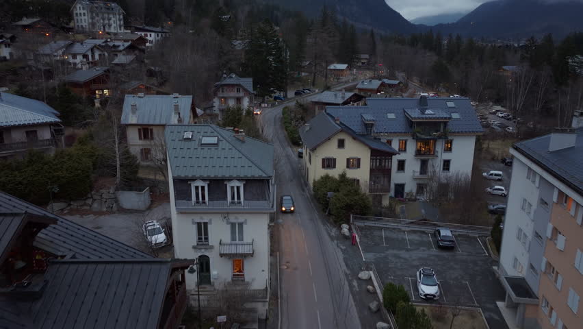 Aerial view of Chamonix village in the French Alps at dusk, featuring traditional chalets and a peaceful atmosphere