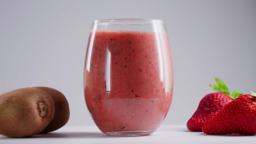 Glass of fresh delicious smoothie made from sweet fruits and berries, healthy eating concept. High quality 4k footage