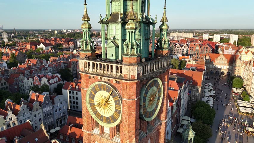 Aerial video shot by drone over the historic tourist center of Gdansk, the city hall and the cathedral on a summer day, Poland, Europe