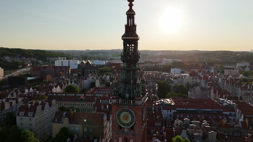 Aerial video shot by drone over the historic tourist center of Gdansk, the city hall and the cathedral on a summer day, Poland, Europe