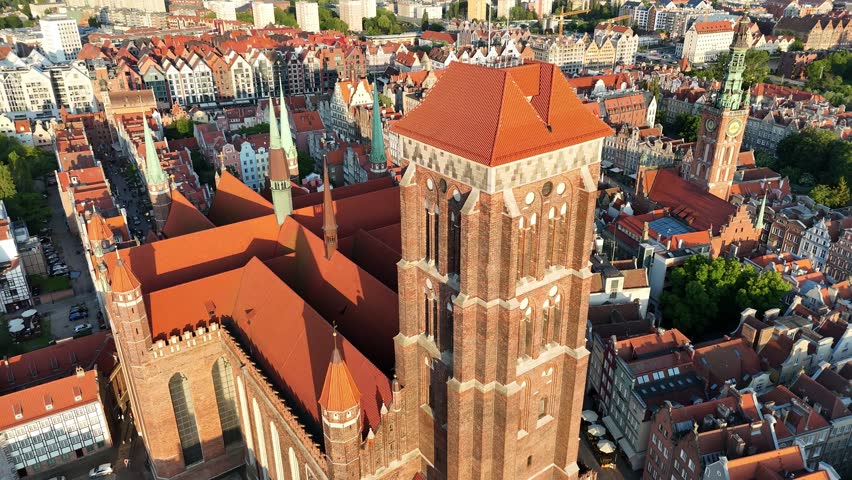 Aerial video shot by drone over the historic tourist center of Gdansk, the city hall and the cathedral on a summer day, Poland, Europe