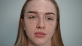 Cosmetologist in purple gloves gently touching the forehead and cheeks of a young woman with closed eyes. Facial skin check-up during professional beauty consultation. - Powered by Shutterstock - Get 15% off with code: PIKWIZARD15
