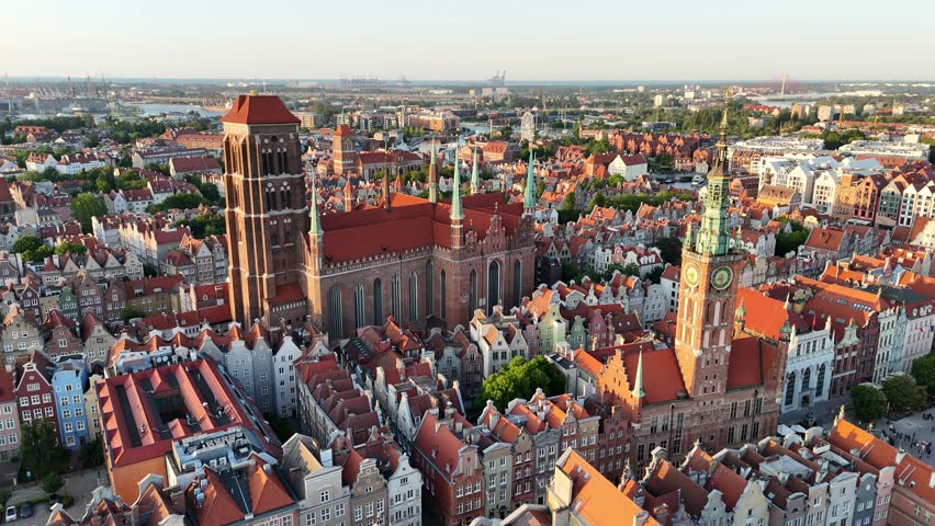 Aerial video shot by drone over the historic tourist center of Gdansk, the city hall and the cathedral on a summer day, Poland, Europe
