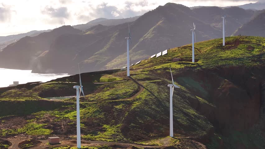 Wind turbines on the rugged hills of Madeira harnessing nature’s energy on a serene afternoon