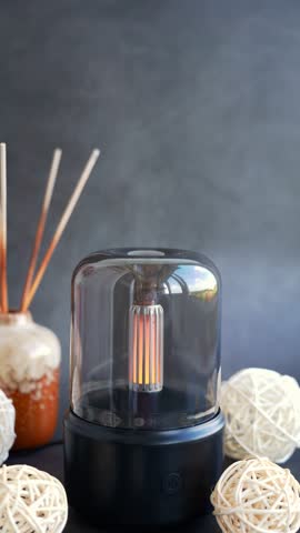 Close up of home perfume scent air humidifier with light. Aromatherapy holistic health practices concept. Stress relief activities preparing for meditation. Simple pleasures healing