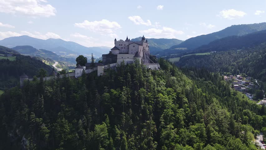Hohenwerfen Castle dominates green mountain ridge in summer light, Austria