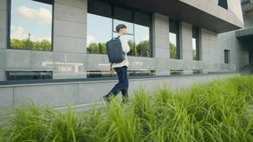 A high school teen climbs steps toward class with a backpack on his shoulders. The modern building and sunlight highlight the beginning of a school day. - Powered by Shutterstock - Get 15% off with code: PIKWIZARD15