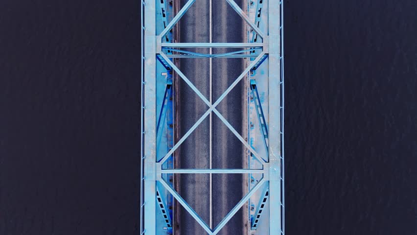Slow drone flight reveals striking blue bridge spanning Lielupe River, Latvia