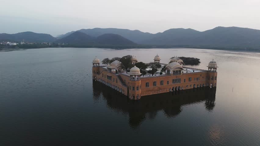 Aerial drone shot highlighting the symmetry and elegance of Jal Mahal in the center of the lake.