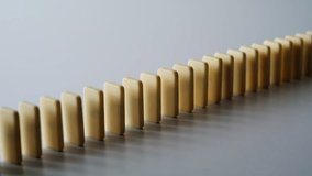 Domino line falling sequence capture physical momentum indoors closeup. Game pieces collapsing in chain reaction display dynamic process. Toy bricks showing cause and effect logic. Kinetic energy. - Powered by Shutterstock - Get 15% off with code: PIKWIZARD15