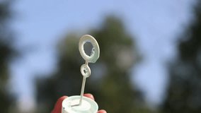 Blowing soap bubbles in the park. Blowing soap bubbles outdoors, close-up. Summer vacation concept, peaceful atmosphere. Unrecognizable person blowing soap bubbles. Outdoor entertainment. Leisure - Powered by Shutterstock - Get 15% off with code: PIKWIZARD15