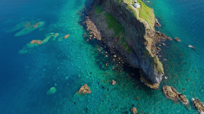 Drone fly above famous cliff in Shakotan Hokkaido, Japanese sea landscape in summer establishing aerial view