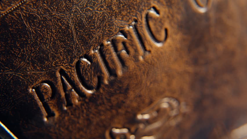 Closeup Pacific ocean engraved on retro globe surface. Beautiful texture vintage Earth model macro view. Geographical objects marked on world map. Exclusive decor element for office home university.