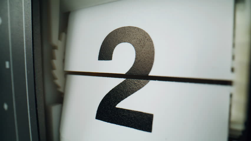 Flip clock changing numbers on white plastic panels closeup. Macro view retro flipclock showing countdown indoors. Time lapse of calendar timepiece. Retro mechanical device measuring seconds flowing.