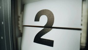 Flip clock changing numbers on white plastic panels closeup. Macro view retro flipclock showing countdown indoors. Time lapse of calendar timepiece. Retro mechanical device measuring seconds flowing. - Powered by Shutterstock - Get 15% off with code: PIKWIZARD15