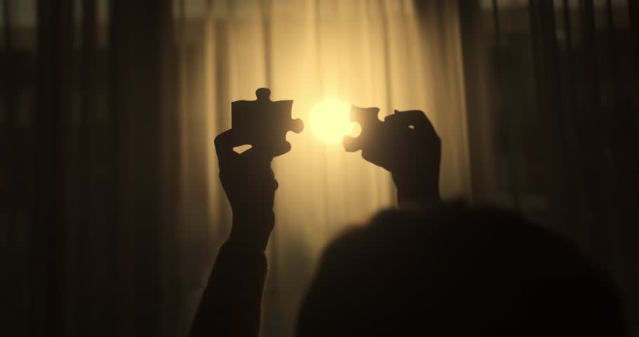 Close Up Hands of Woman Connecting Jigsaw Puzzle With Sunlight Affect. Business Solutions, Success Strategy. Two Hands Connect Couple Puzzle. One Part of Whole Symbol of Association and Connection.