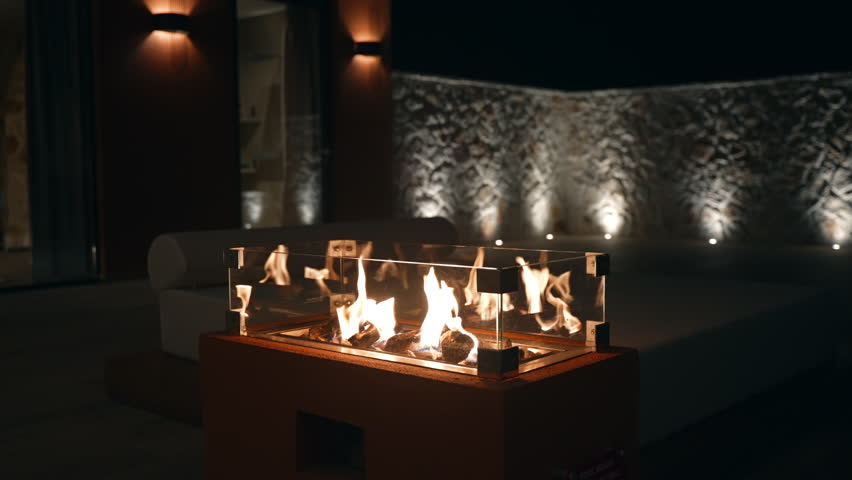 Modern Outdoor Gas Fireplace at Night with Decorative Flames