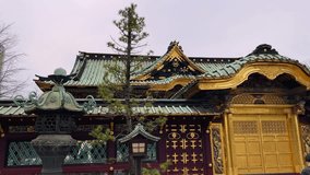 Meiji Jingu Shrine in Tokyo, Japan. Ornate details of the shrine's architecture, including traditional Japanese lanterns and golden features, are showcased against a muted sky. A serene atmosphere - Powered by Shutterstock - Get 15% off with code: PIKWIZARD15
