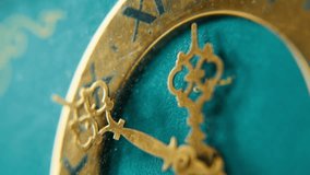Macro view beautiful vintage clock with figure metal hands at turquoise background. Closeup old retro timepiece showing time indoors. Elegant exclusive timekeeper have circle dial with roman numbers. - Powered by Shutterstock - Get 15% off with code: PIKWIZARD15