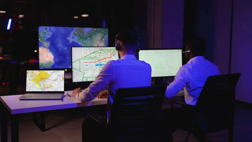Two logistics dispatchers tracking freight trucks on screens - Powered by Shutterstock - Get 15% off with code: PIKWIZARD15
