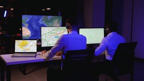 Two logistics dispatchers tracking freight trucks on screens - Powered by Shutterstock - Get 15% off with code: PIKWIZARD15