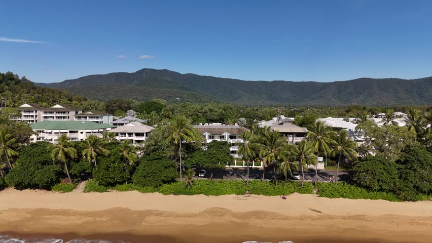 Trinity Beach, Cairns, Queensland: 4K Aerial Drone Footage Featuring Scenic Shoreline, Taylor Point, Coral Sea, Palm Fringed Town, Coastal Hotels, and Lush Tropical Forest Along Australia Coast