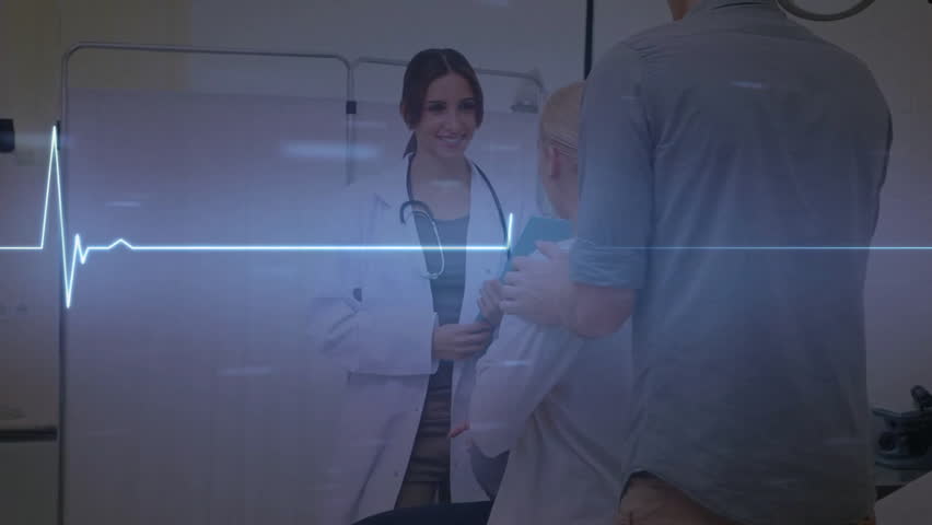 Doctor explaining results while EKG line pulses in health consult with companion supporting. Medical, healthcare, professionalism, reassurance, teamwork, clinical, diagnostic