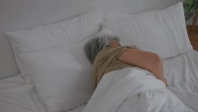 Asian frustrated insomnia senior woman lying down on bed in bedroom. Attractive depressed sleepless elderly mature grandmother feel upset, worried and concern cannot sleep from nightmare in cozy room. - Powered by Shutterstock - Get 15% off with code: PIKWIZARD15