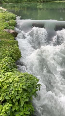Rushing Water over a Small Waterfall or Water Rapid 