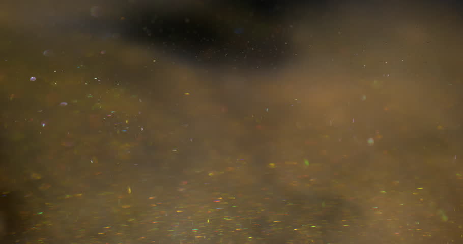 Shimmering liquid. Ink wave. Golden sand metallic powder blend art mist water. Shiny flow splash spread color abstract background.
