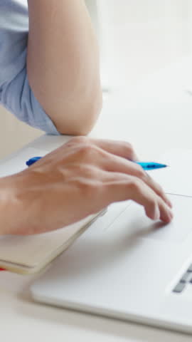 Vertical Screen : Asia businessman using laptop being upset about work, tearing papers and screaming in living room at home. Working from home, remotely work, social distancing, quarantine concept.