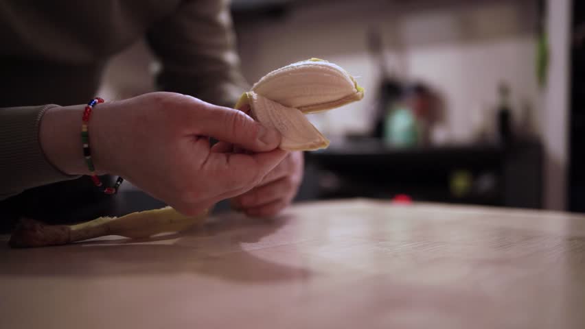 Man Peeling a Banana — Simple Healthy Snack Preparation
