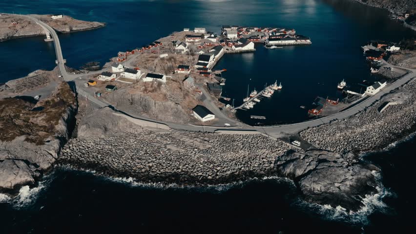 Reine, Lofoten Islands, Nordland, Norway - A Small Fishing Village Nestles Among Rocky Cliffs, With Boats Dotting its Calm Harbor - Orbit Drone Shot