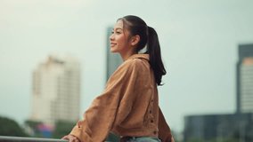 Cheerful asian woman standing on bridge in city park enjoying fresh air and nature – happy female smiling and breathing deeply in urban green space, mindful wellness lifestyle and outdoor relaxation - Powered by Shutterstock - Get 15% off with code: PIKWIZARD15