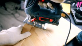 worker using electric tool for cutting wood. gloved hand using an electric jigsaw to cut wooden board in a workshop. DIY woodworking project in progress, with tools and equipment. cutting wood diy  - Powered by Shutterstock - Get 15% off with code: PIKWIZARD15