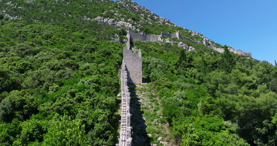 Person Going Down The Ston Walls In The Mountain In Croatia. - aerial shot